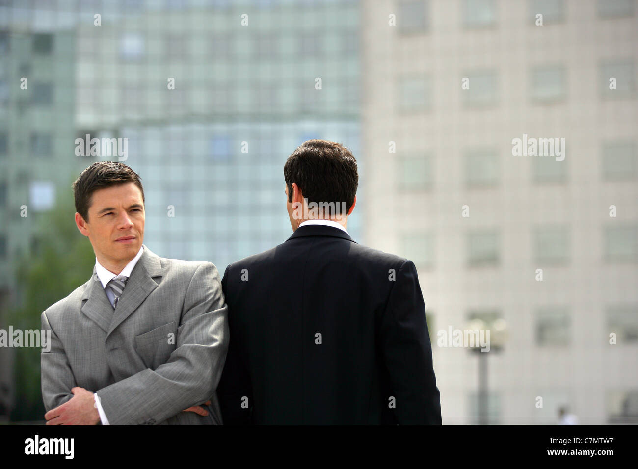 Businessmen having conversation in office hi-res stock photography and ...