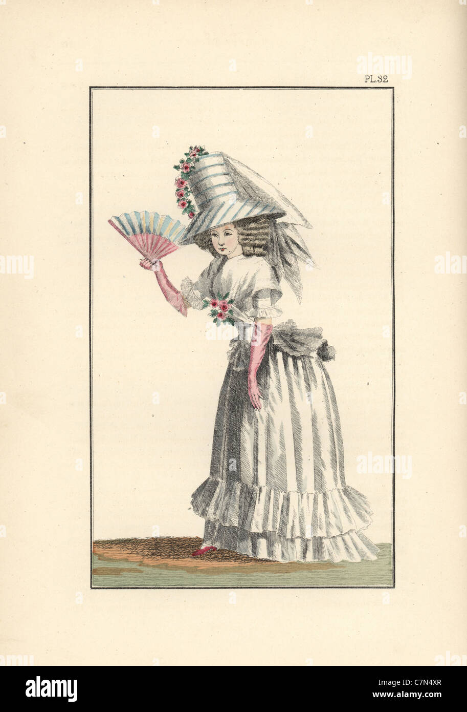 Woman in a white chiffon dress, white petticoat with double furbelow, and a tall white taffeta Theodore hat. Stock Photo