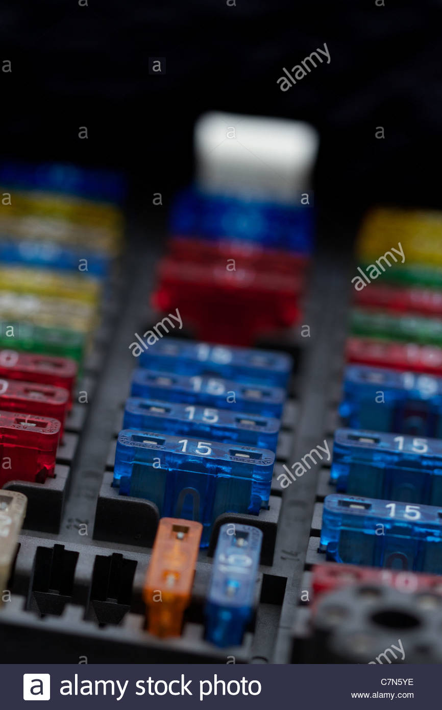 Different regular size blade type fuses in car fuse box. Shallow depth of  field.
