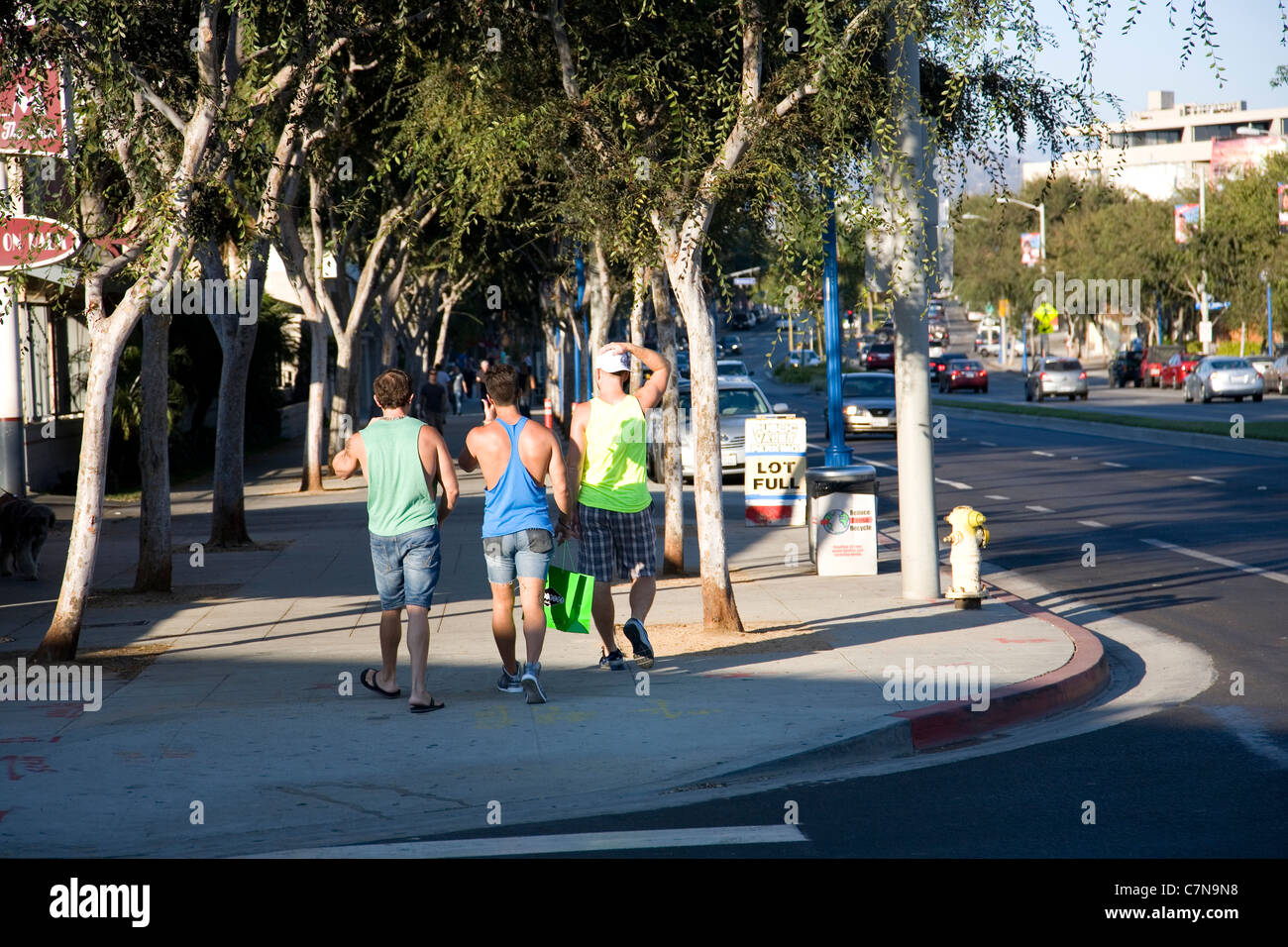 Three guys walking along Santa Monica in West Hollywood Stock Photo