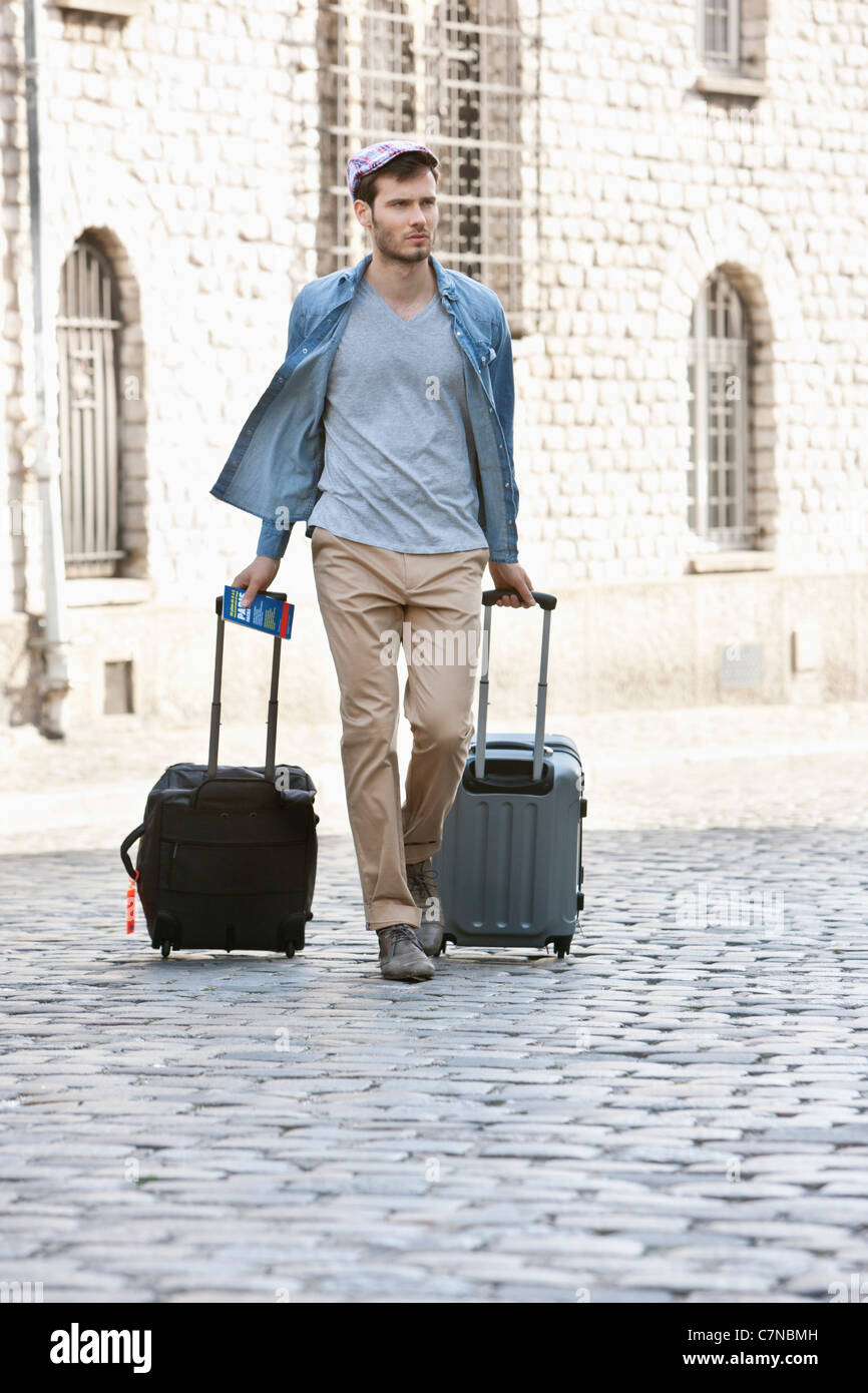 Man pulling trolley bags on the road, Paris, Ile-de-France, France Stock  Photo - Alamy