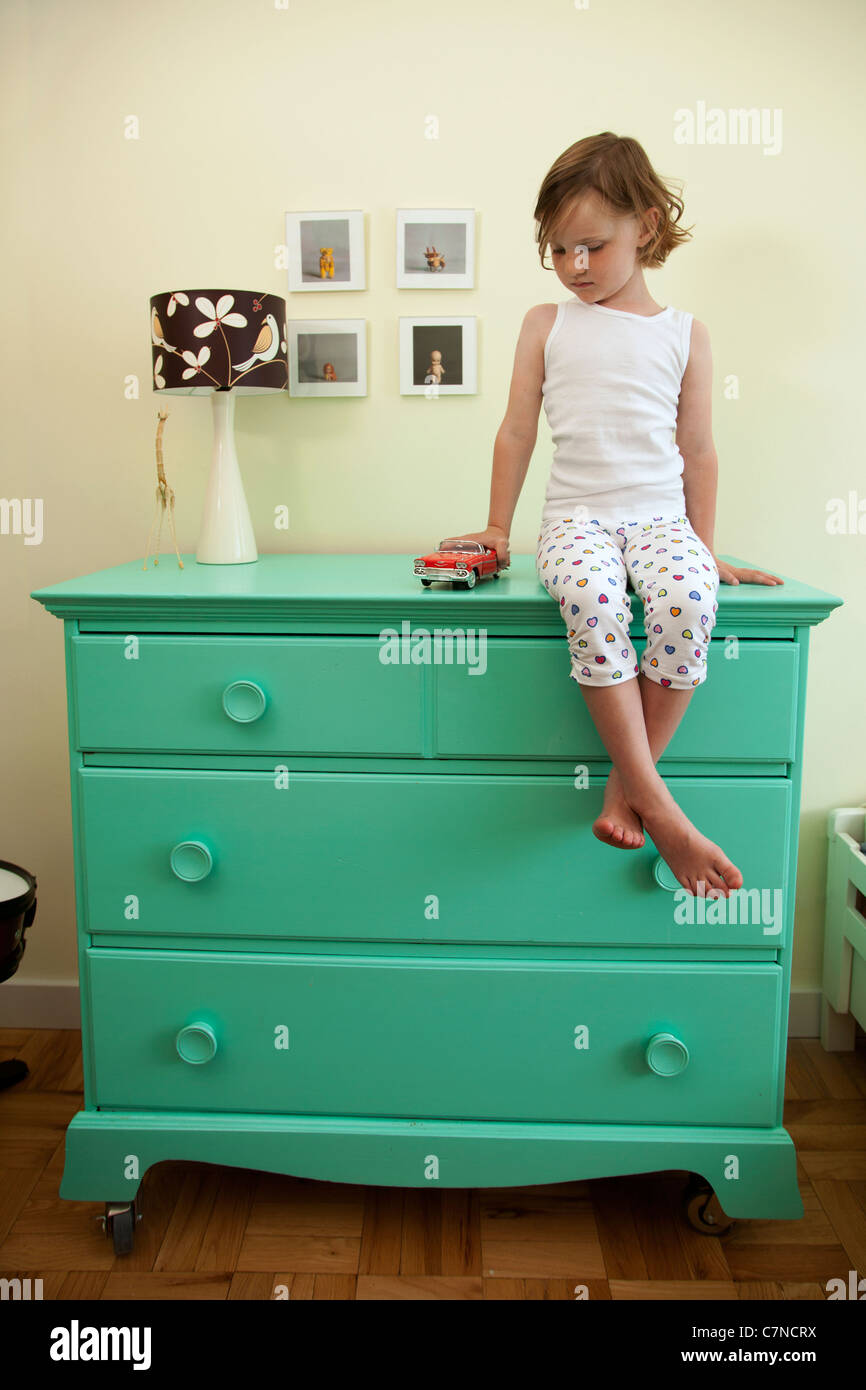 Little Girl Sitting On A Green Dresser Stock Photo 39194398 Alamy