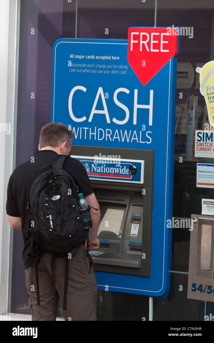 A man uses a Nationwide ATM to withdraw cash Stock Photo