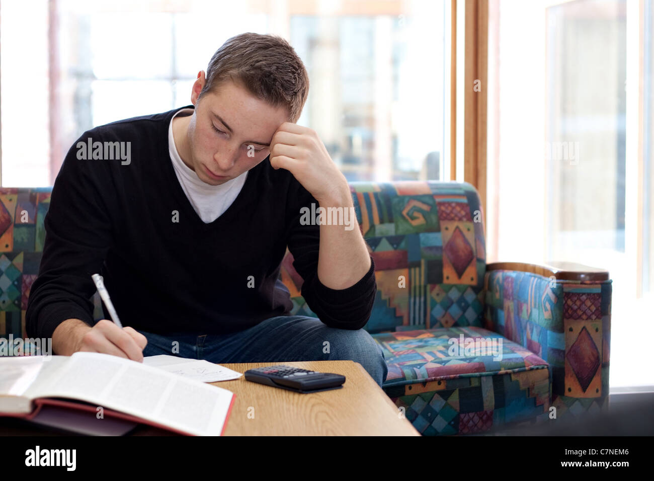 A young college student cramming before his final exams. Stock Photo