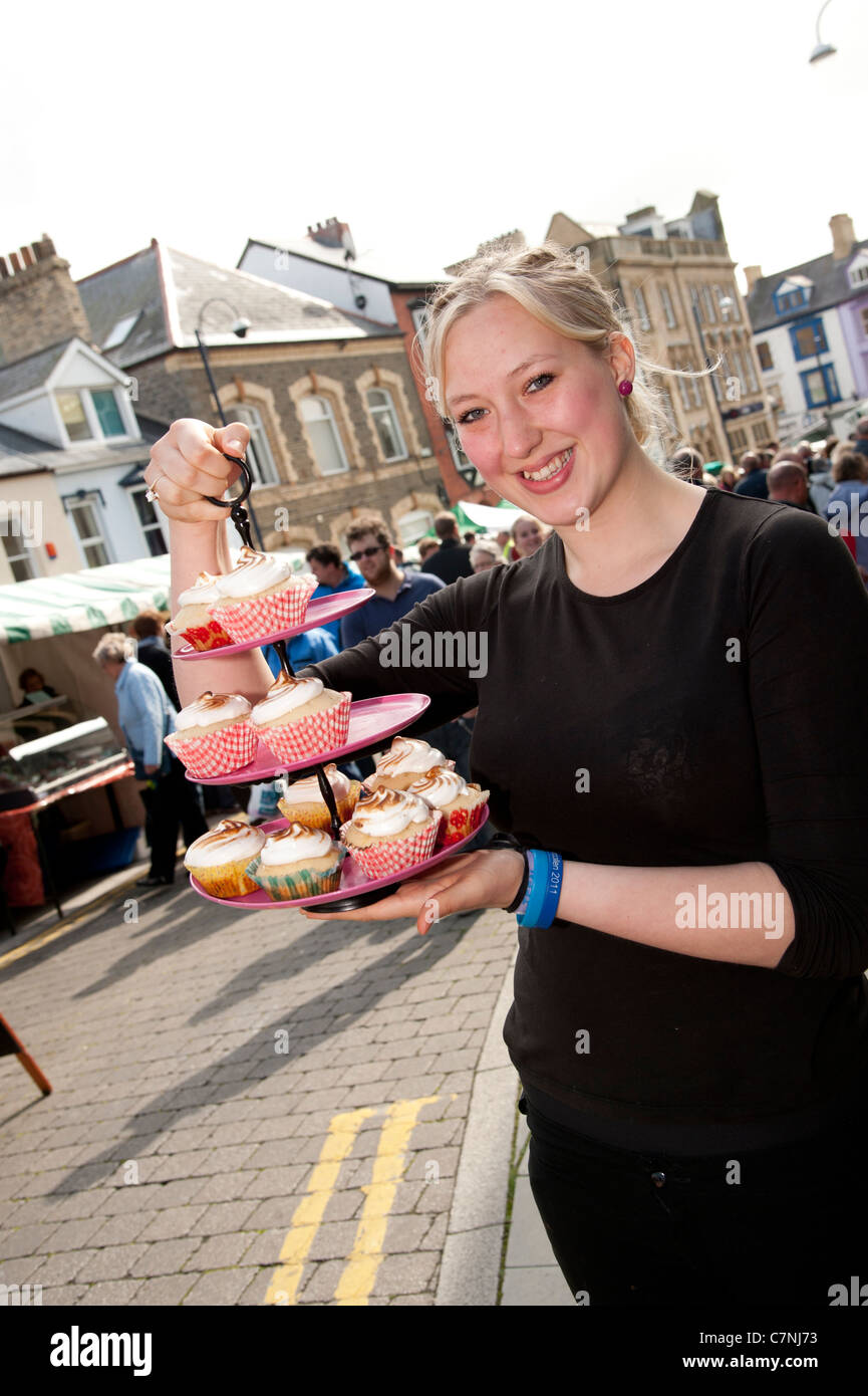 A young woman selling fresh made cup cakes at Aberystwyth Food Fair, September 2011, Wales UK Stock Photo