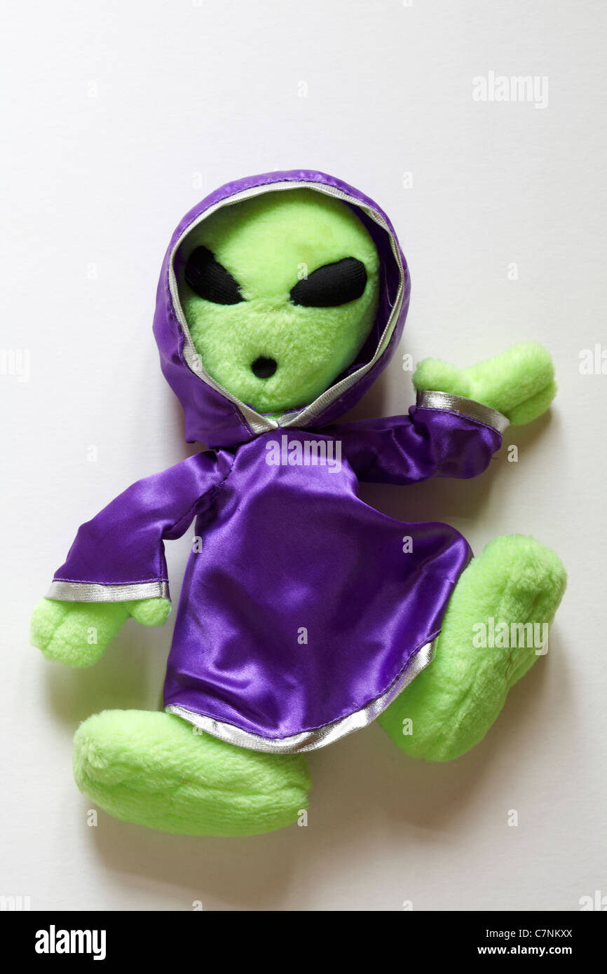 Green alien soft toy dressed in purple robe isolated on white background  Stock Photo - Alamy