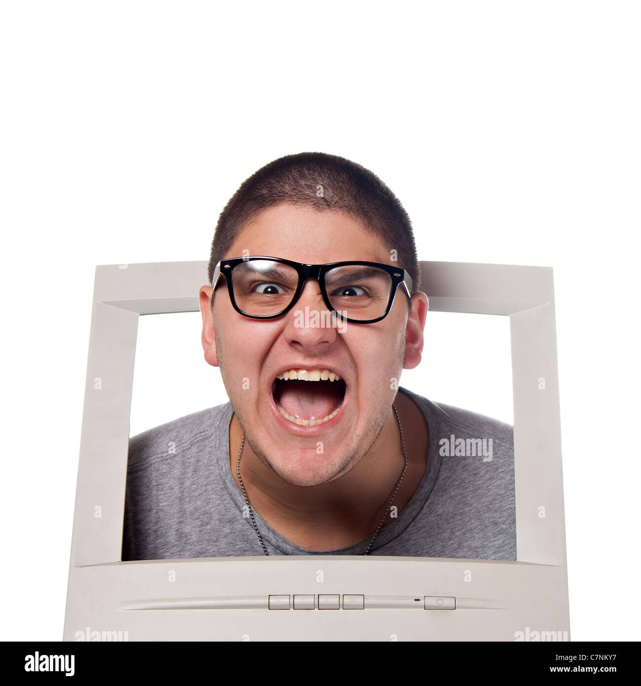 A young man popping his head out of a computer monitor with nerd glasses. Stock Photo
