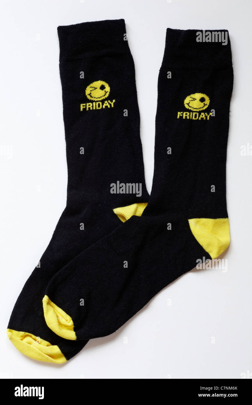 Novelty pair of socks with yellow smiley face and Friday on, isolated on white background Stock Photo