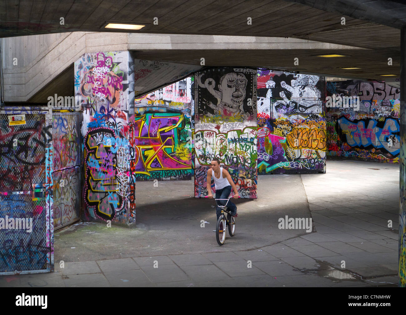 Grafitti-land on the South Bank, London- speeding cyclist Stock Photo