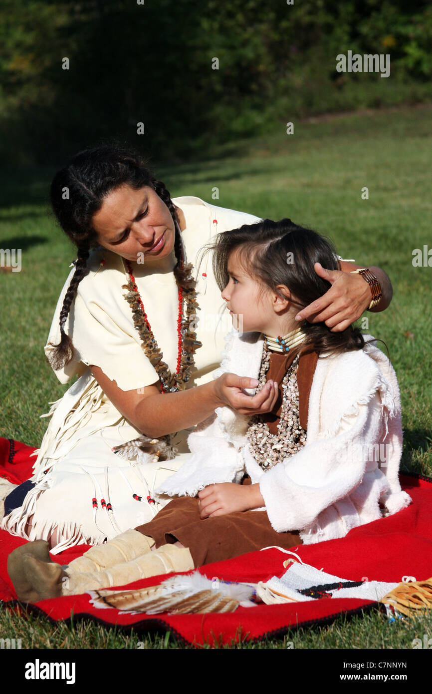 A Native American Indian woman braiding her childs hair Stock Photo - Alamy
