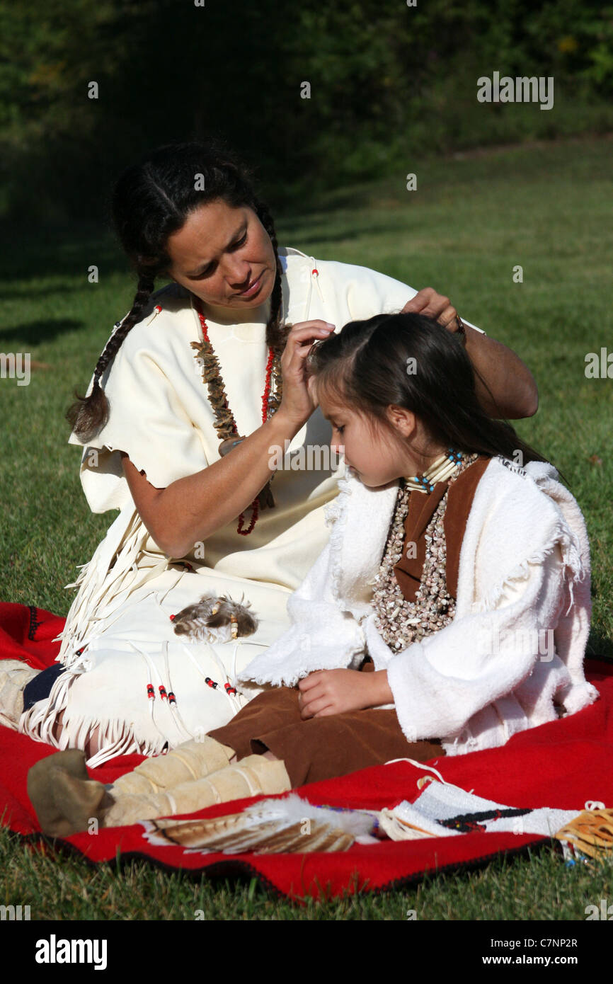 A Native American Indian woman braiding her childs hair Stock Photo - Alamy