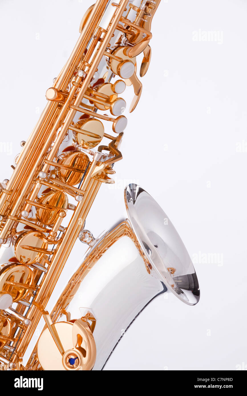 A silver and gold saxophone isolated against a white background. Stock Photo