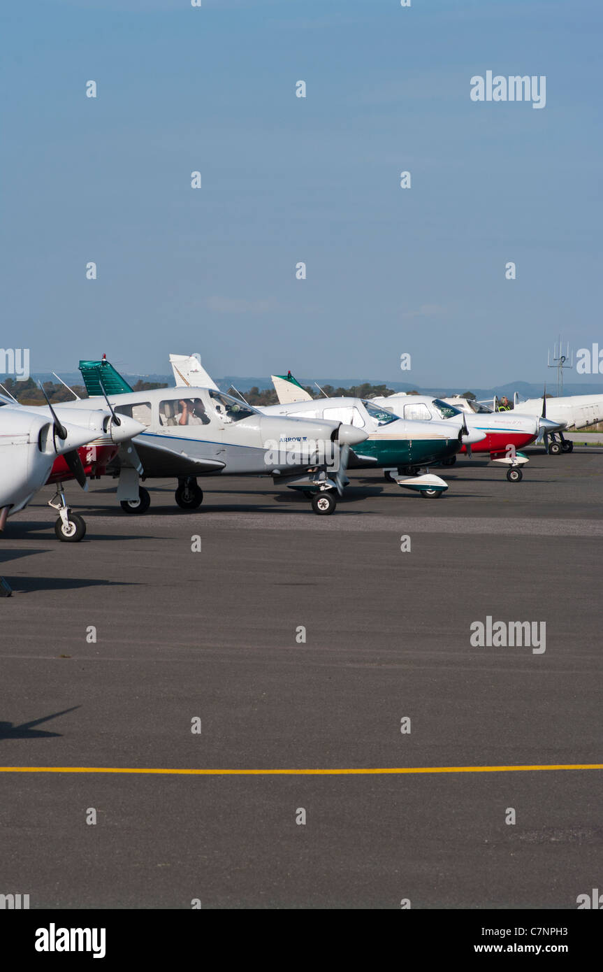 Row Of Single Engine Small Light Aircraft Planes On The Tarmac At Lydd Airport Kent England Stock Photo