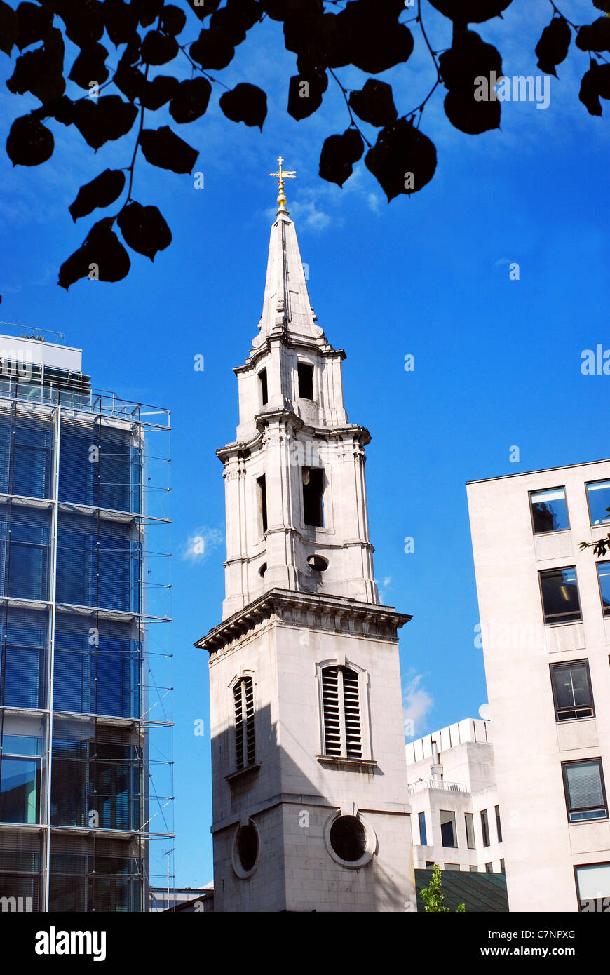 Steeple of St. Vedast's Church, founded in 1170, harmonizes with modern buildings in Cheapside, London, England, on a sunny day. Stock Photo