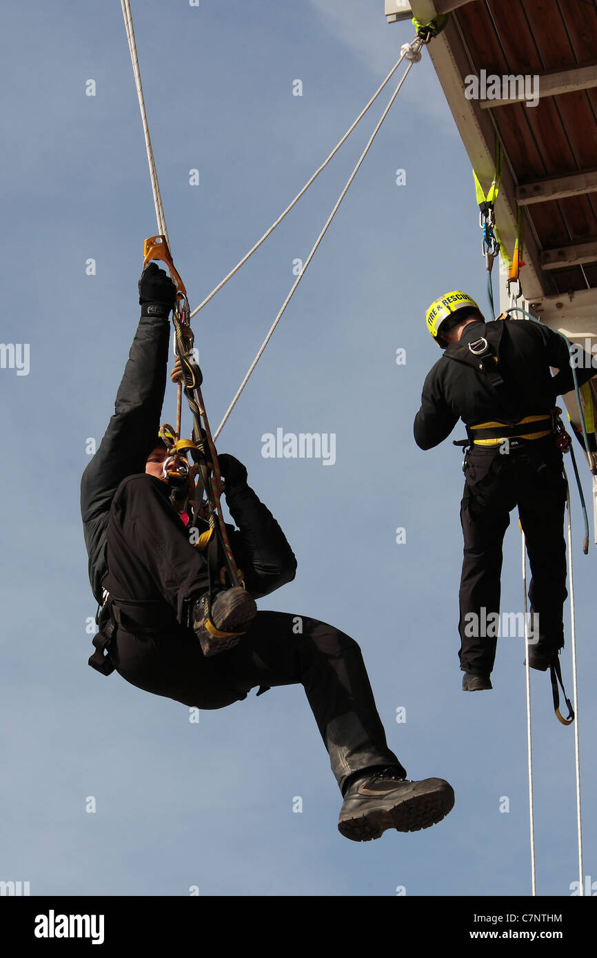 Two firemen carrying out rope rescue drill Stock Photo - Alamy