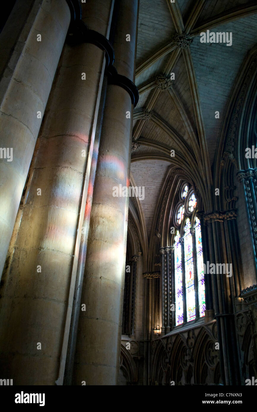 Light from a stained glass window shining on a pillar in Lincoln