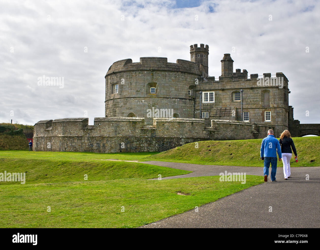 Tourists walking along a path towards Pendennis Castle in Cornwall Stock Photo