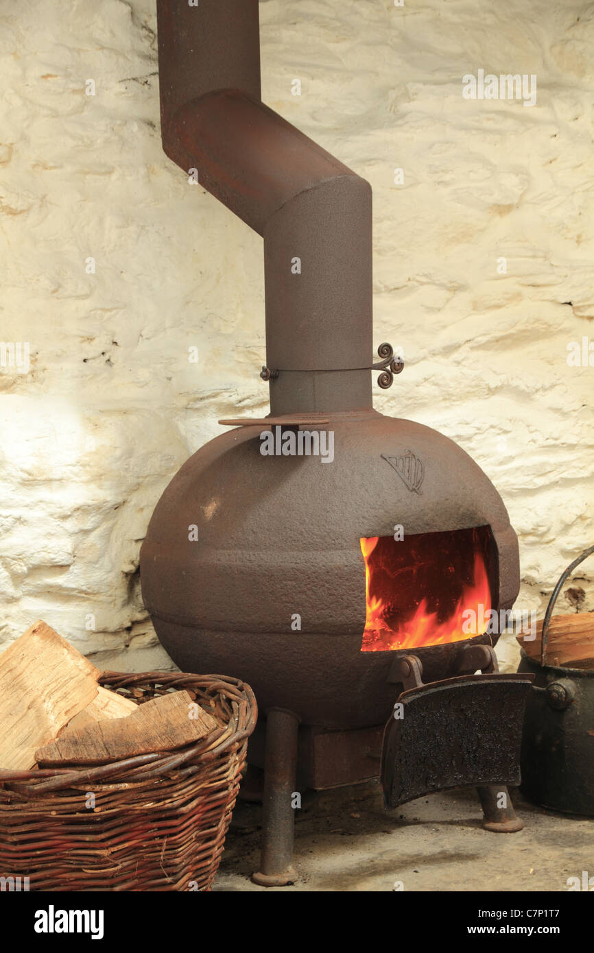 A pot bellied stove in a traditional Irish fireplace, County Kerry, Rep. of Ireland Stock Photo