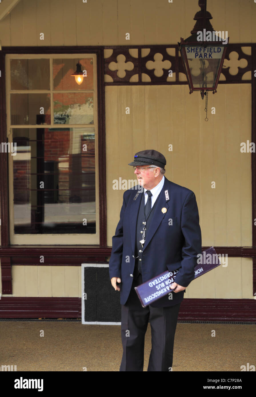 The station master waits on the platform at The Bluebell Line Steam Railway, Sheffield park, West Sussex, England. Stock Photo
