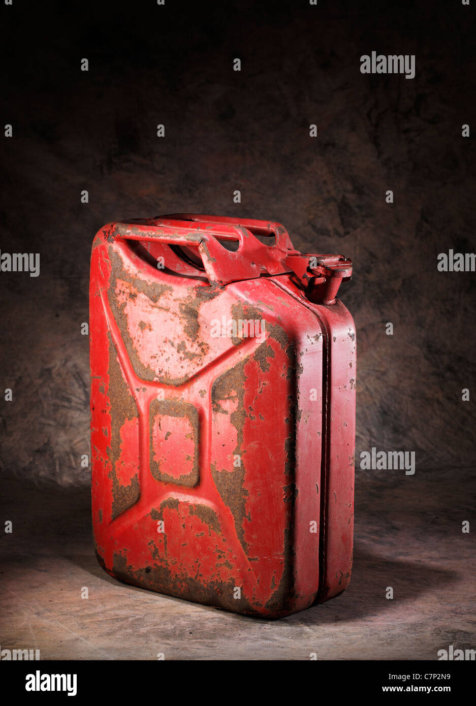 Old rusty red metallic jerry can. Stock Photo