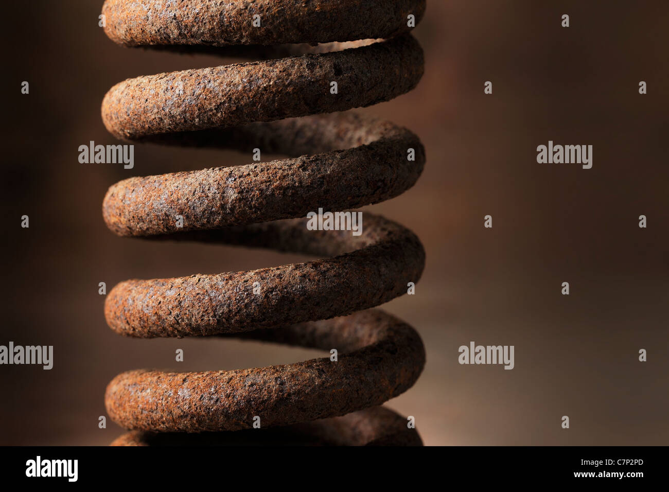 Old metallic rusty spring in closeup. Stock Photo