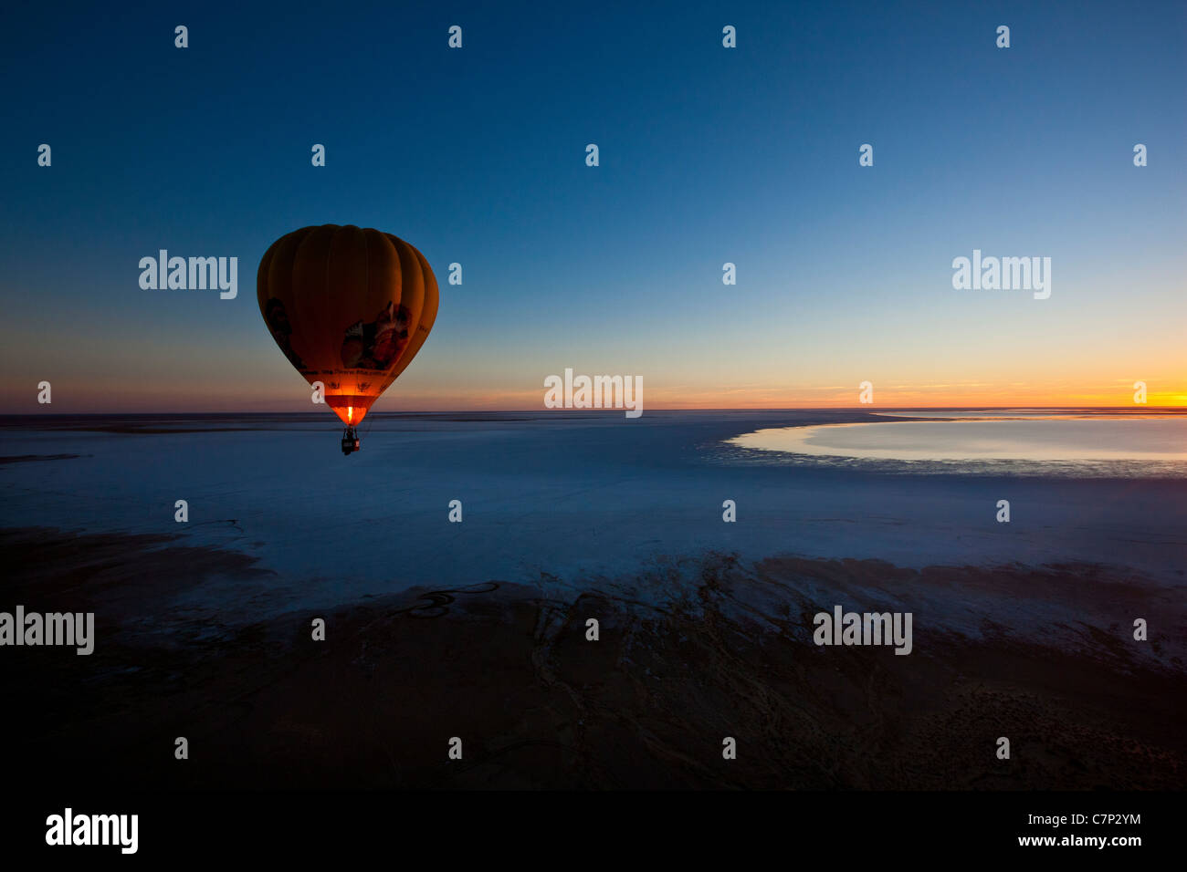 Hot air balloon flying low over Lake Eyre South, Australia Stock Photo