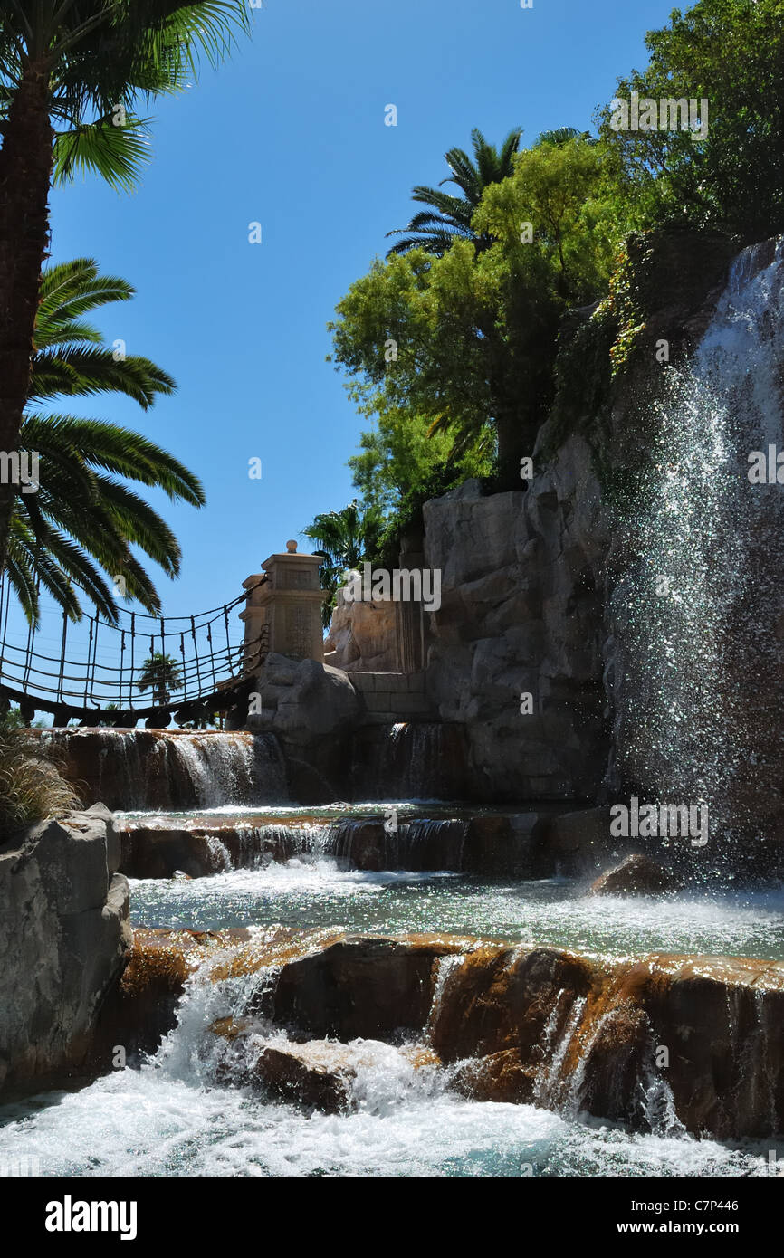 Waterfalls,rock pools, palm trees and a rope bridge under a perfect