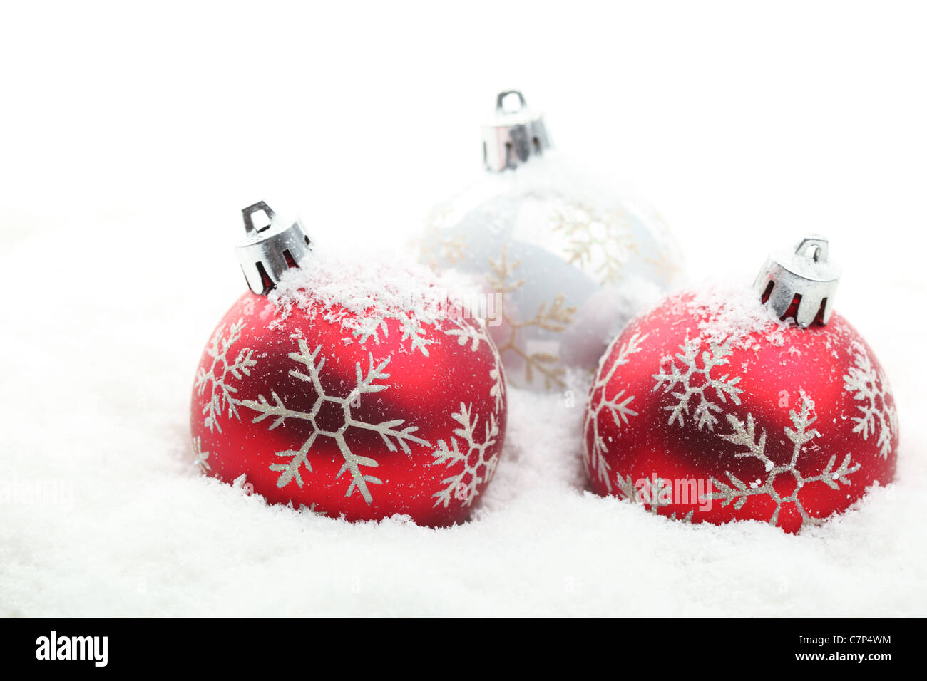 Red and white Christmas balls in snow flakes,Shallow Dof. Stock Photo