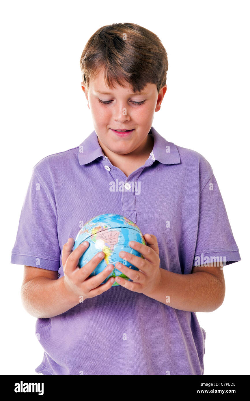 Photo of an 11 year old school boy holding a world globe, isolated on a white background. Stock Photo