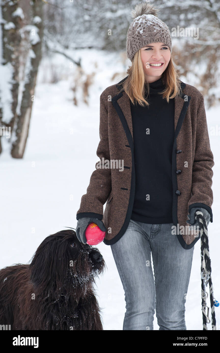 Woman walking dog in snow Stock Photo Alamy