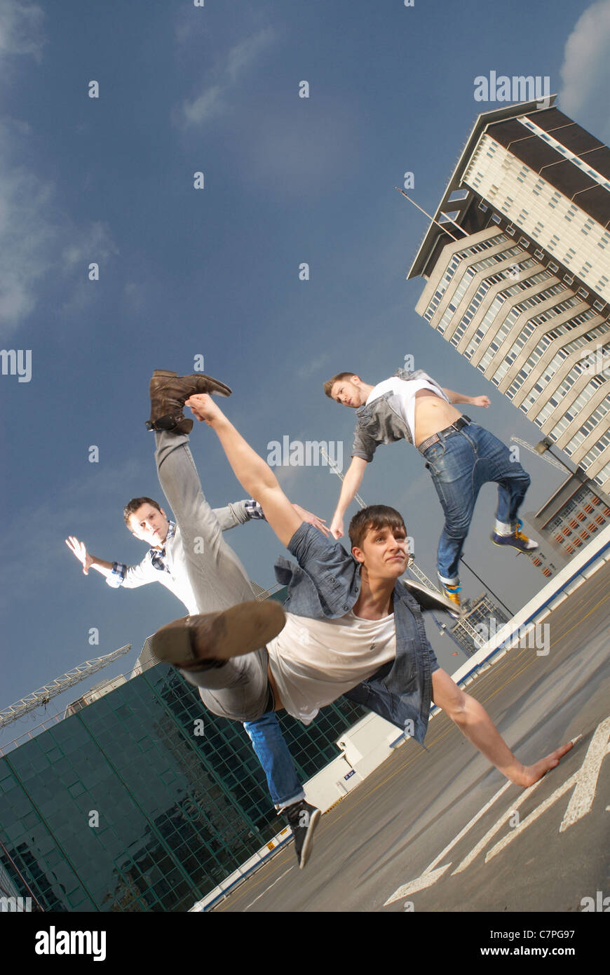 Men dancing on urban rooftop Stock Photo