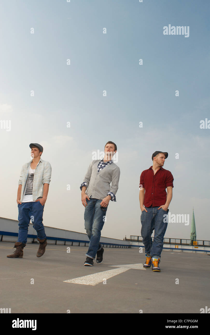 Men walking together on rooftop Stock Photo
