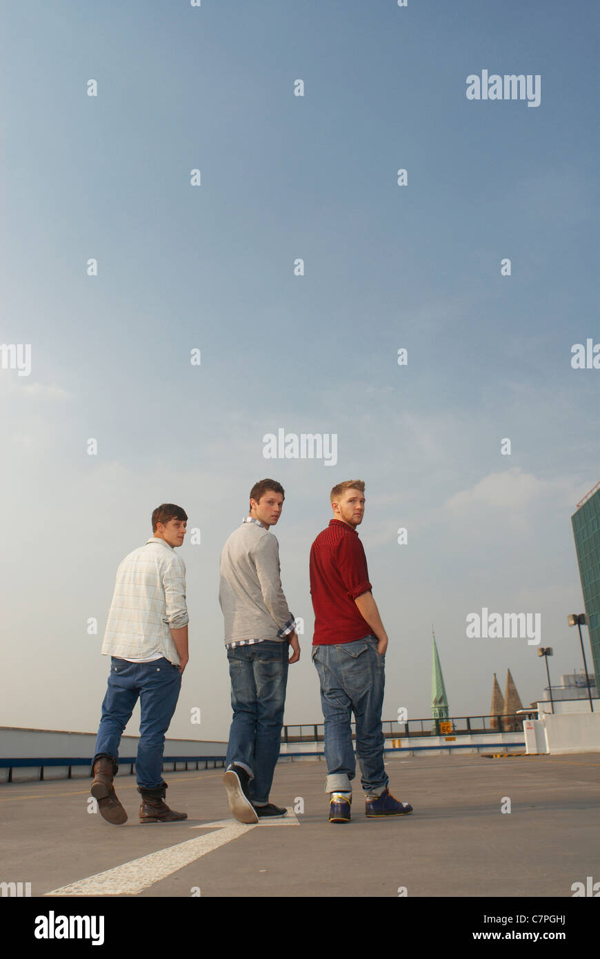 Men walking together on rooftop Stock Photo