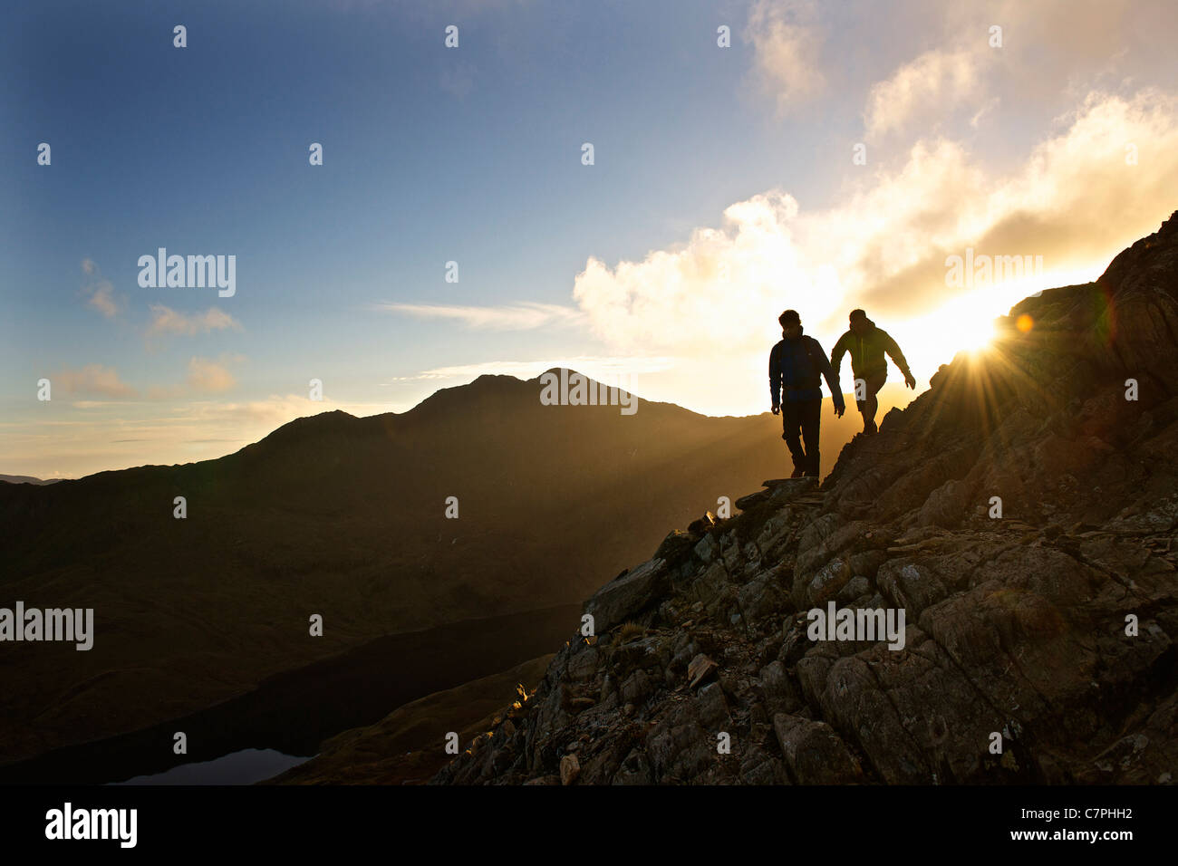 Men hiking on rocky mountainside Stock Photo