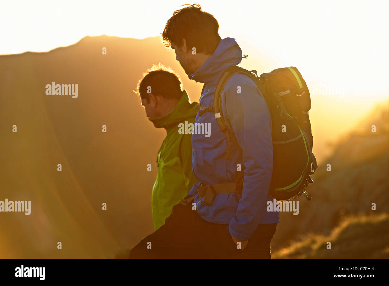 Men hiking on mountainside Stock Photo
