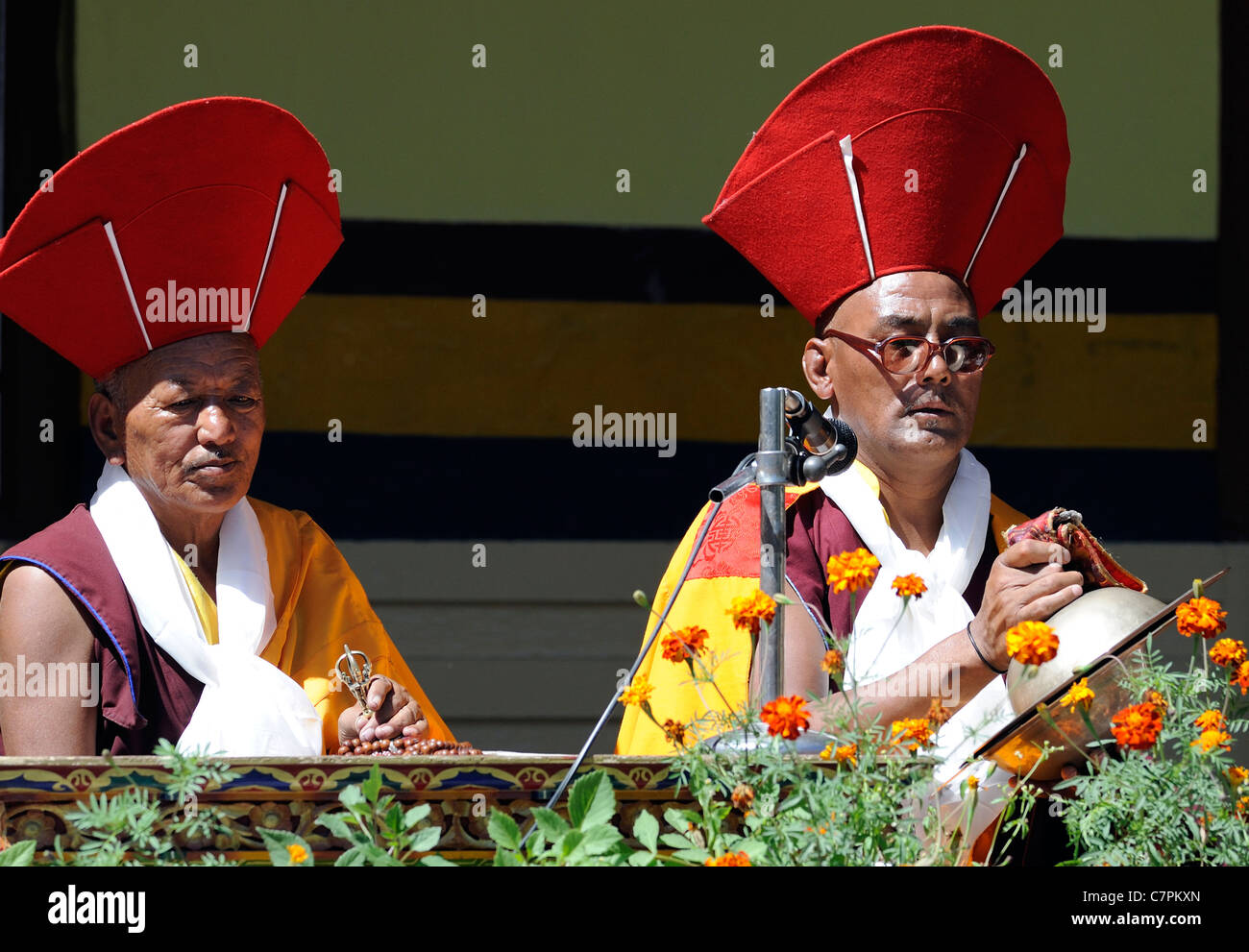 Monks chant and play bell and cymbals to accompany masked dancers at the Leh festival in the courtyard of  the Chowkhang gompa. Stock Photo