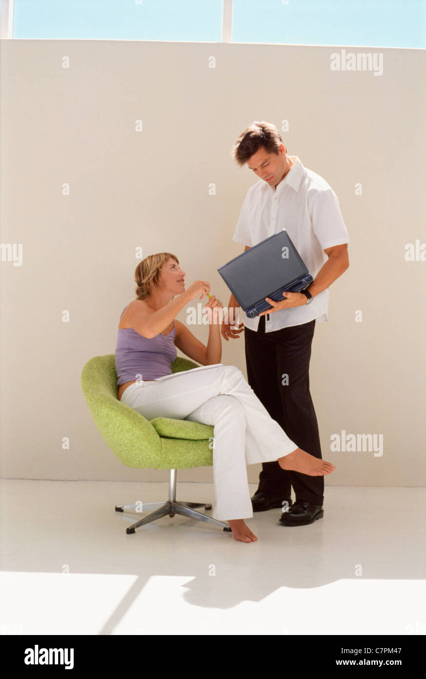 Business people using laptop together Stock Photo - Alamy