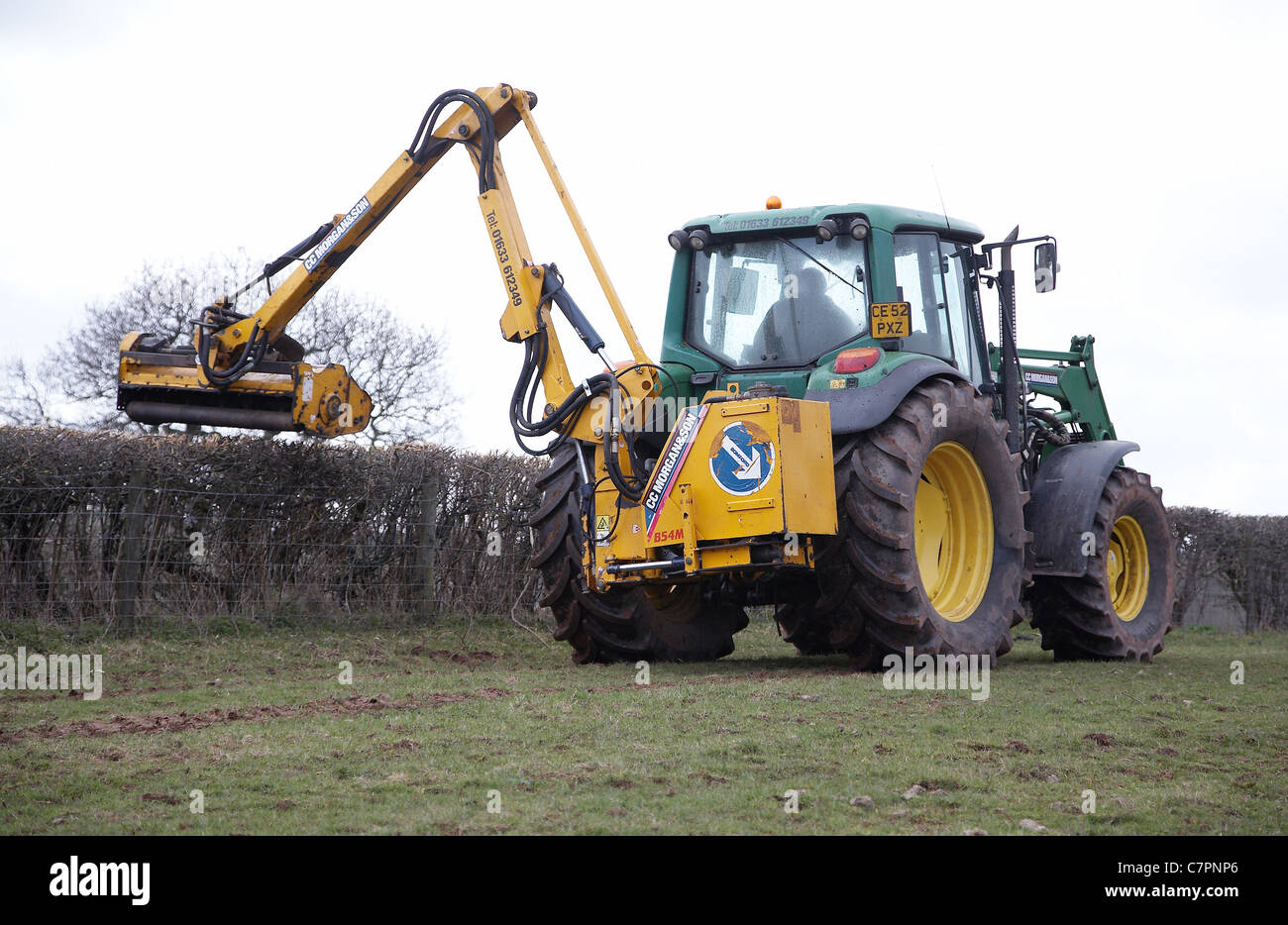 Tractor cutting hedges on farmland in south Wales Stock Photo Alamy