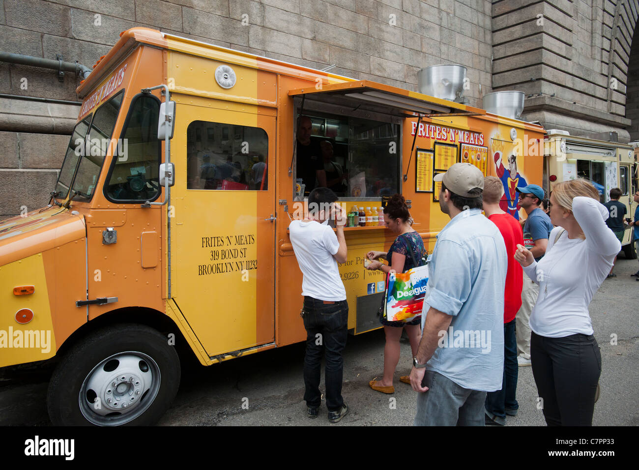 Customers Line Up To Buy Meals From The Frites And Meats