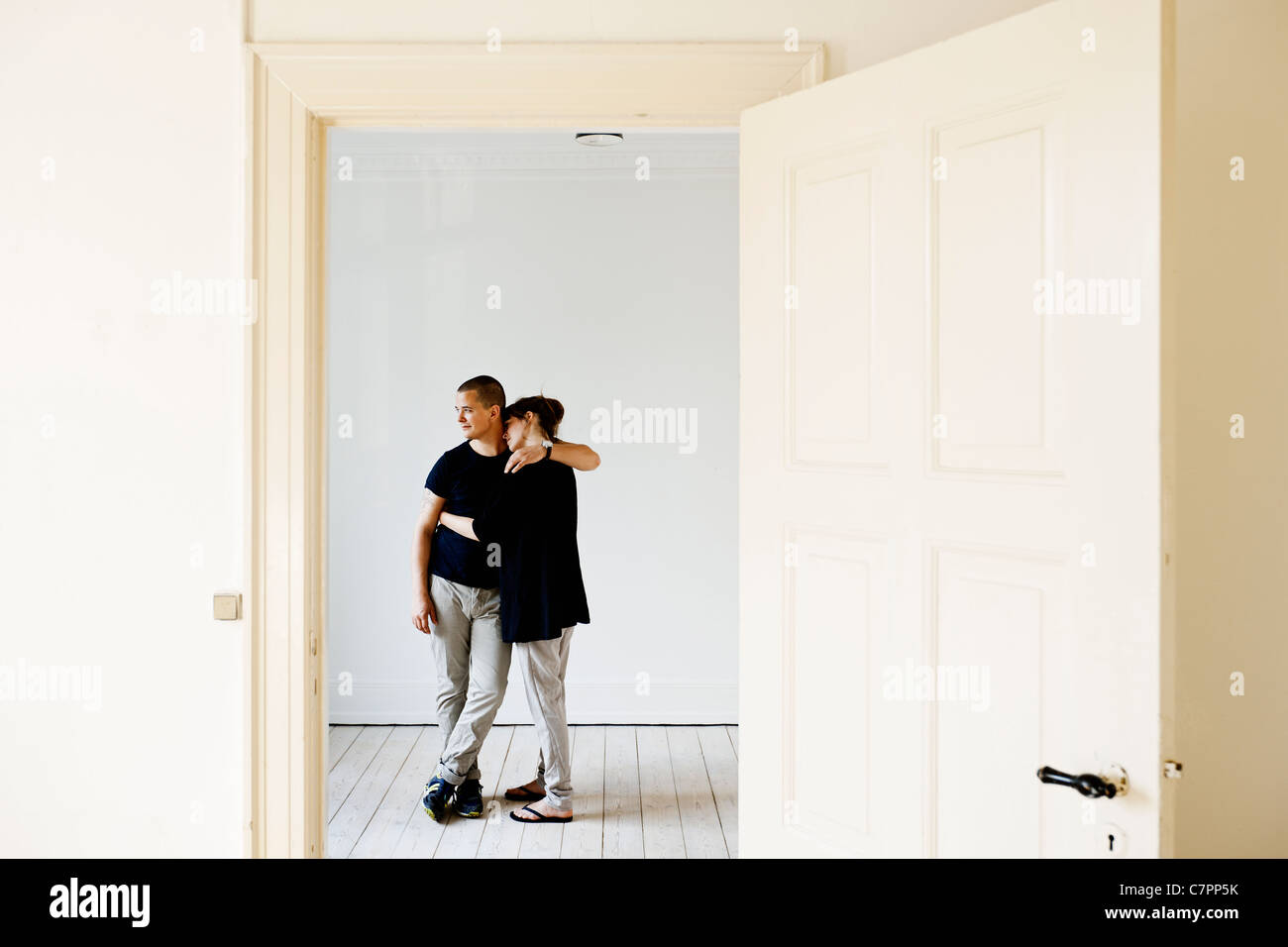 Couple hugging in new home Stock Photo