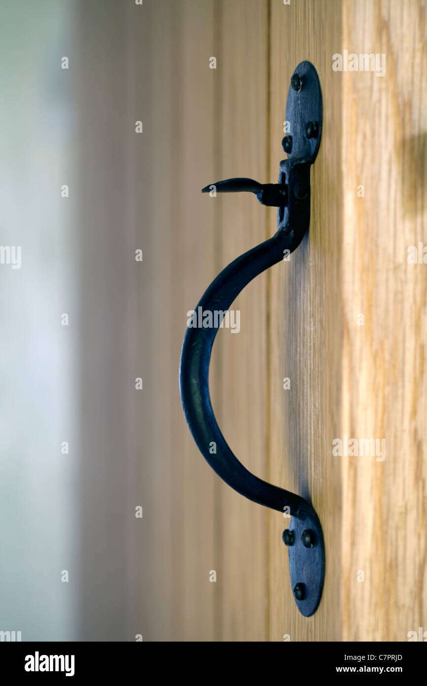 Hand made suffolk latch door latch opener on an oak door Stock