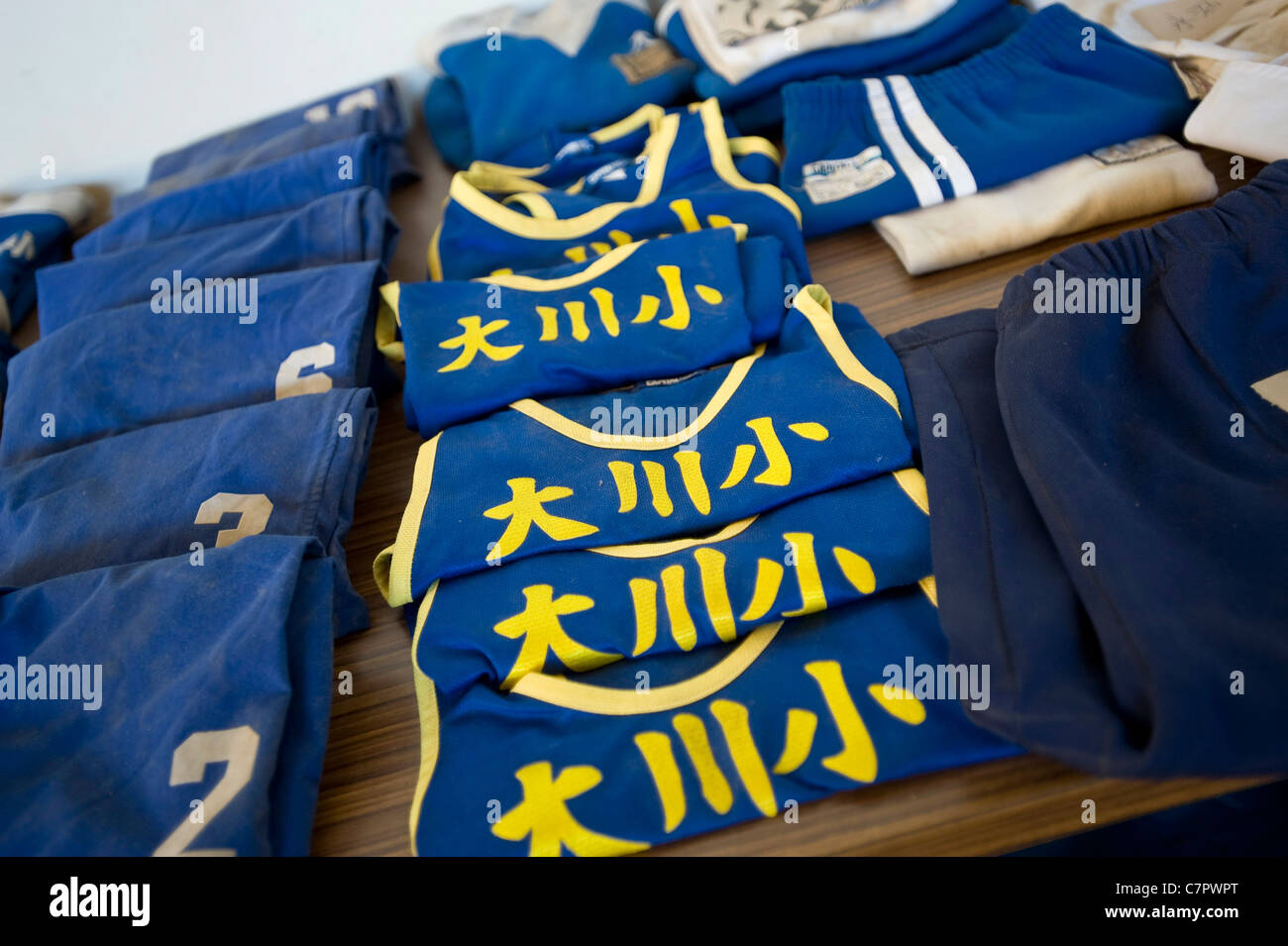 Vests and other gym clothes belonging to elementary school children from Okawa elementary school, are laid out in a repository Stock Photo