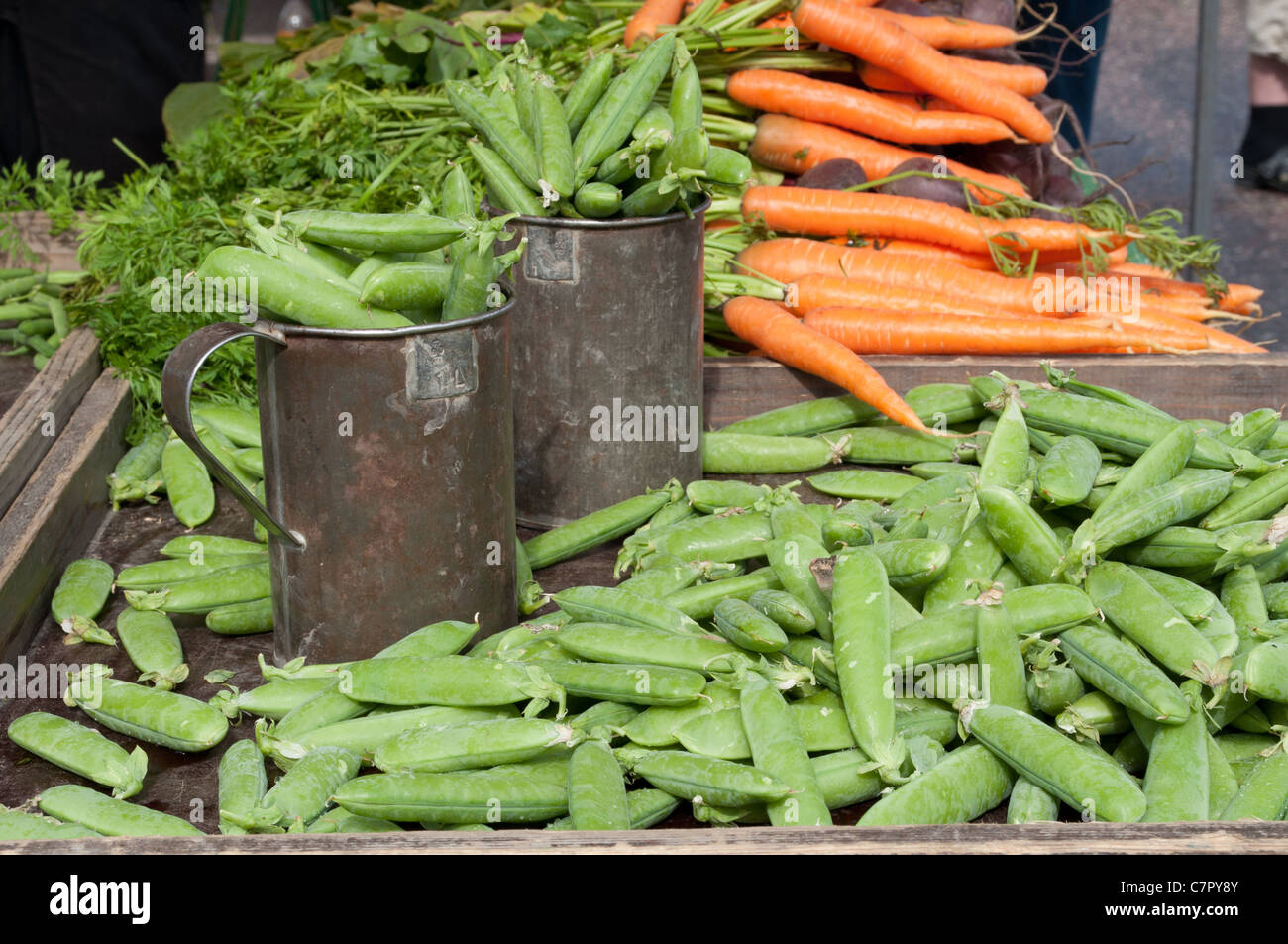 Pods and peas with carrots on a market stall Stock Photo Alamy
