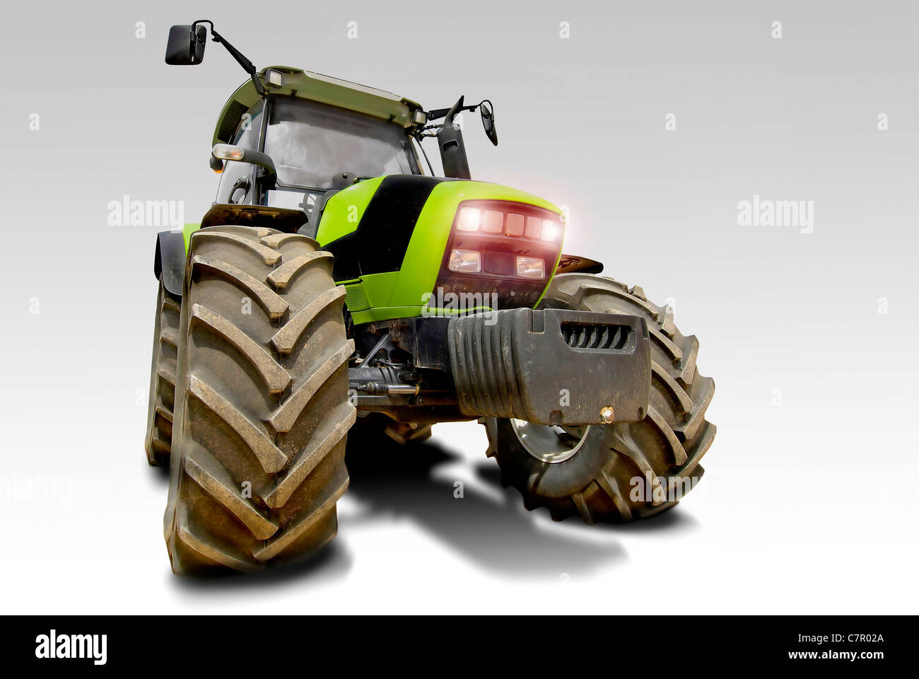 Green tractor isolated in white Stock Photo - Alamy