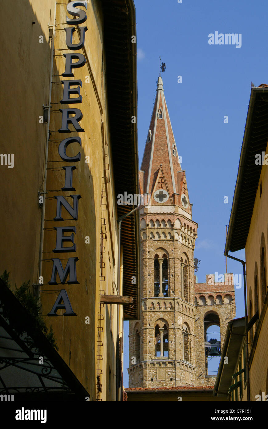 Gothic red brick church spire on hexagonal stone bell tower (campanile) in Florence, Italy Stock Photo