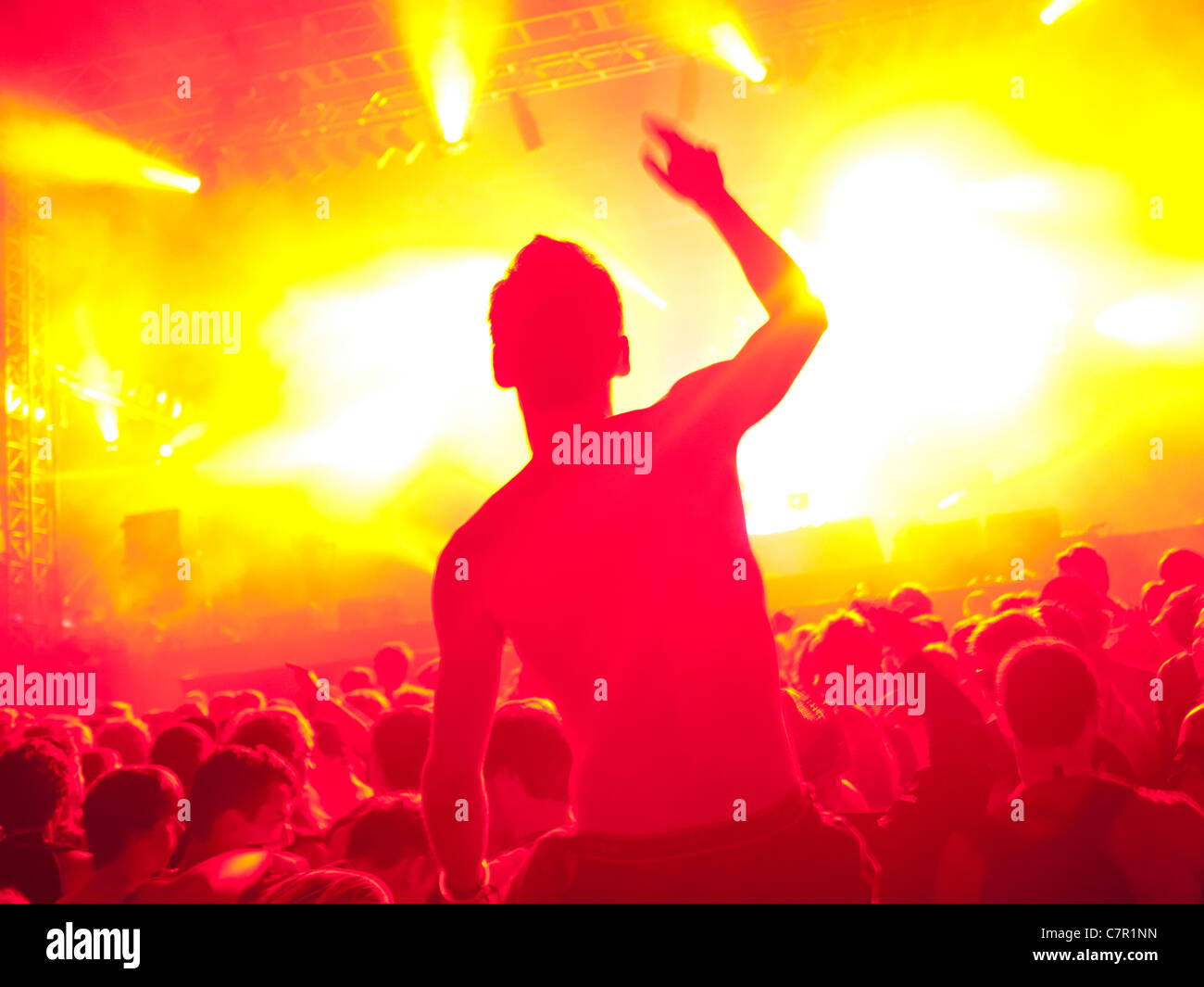 A music fan on someones shoulders at a music festival Stock Photo
