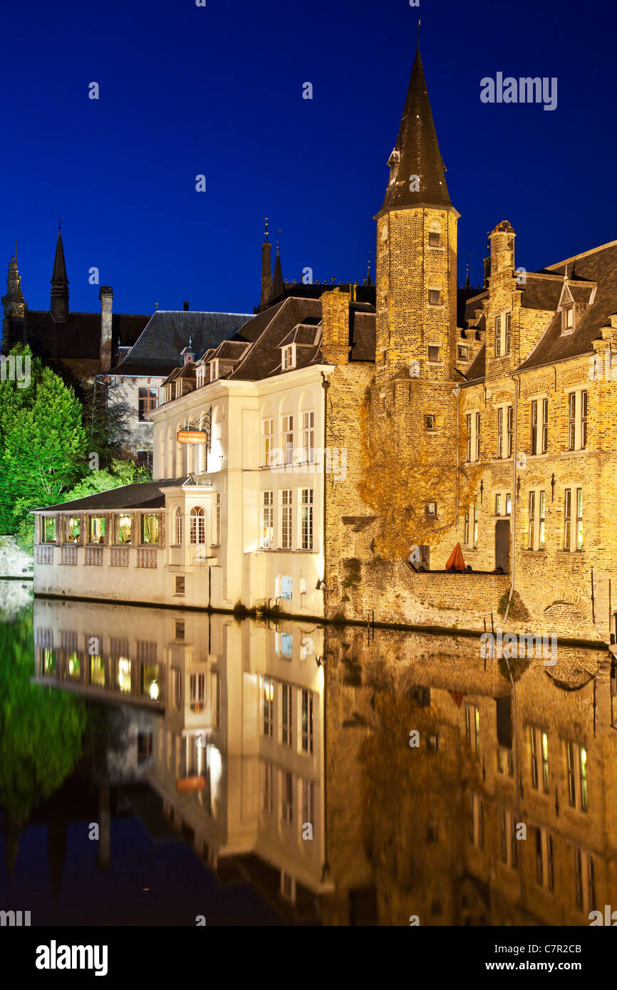 Twilight view from the Rozenhoedkaai in Bruges, Flanders, Belgium at dusk with reflections of floodlit medieval houses. Stock Photo