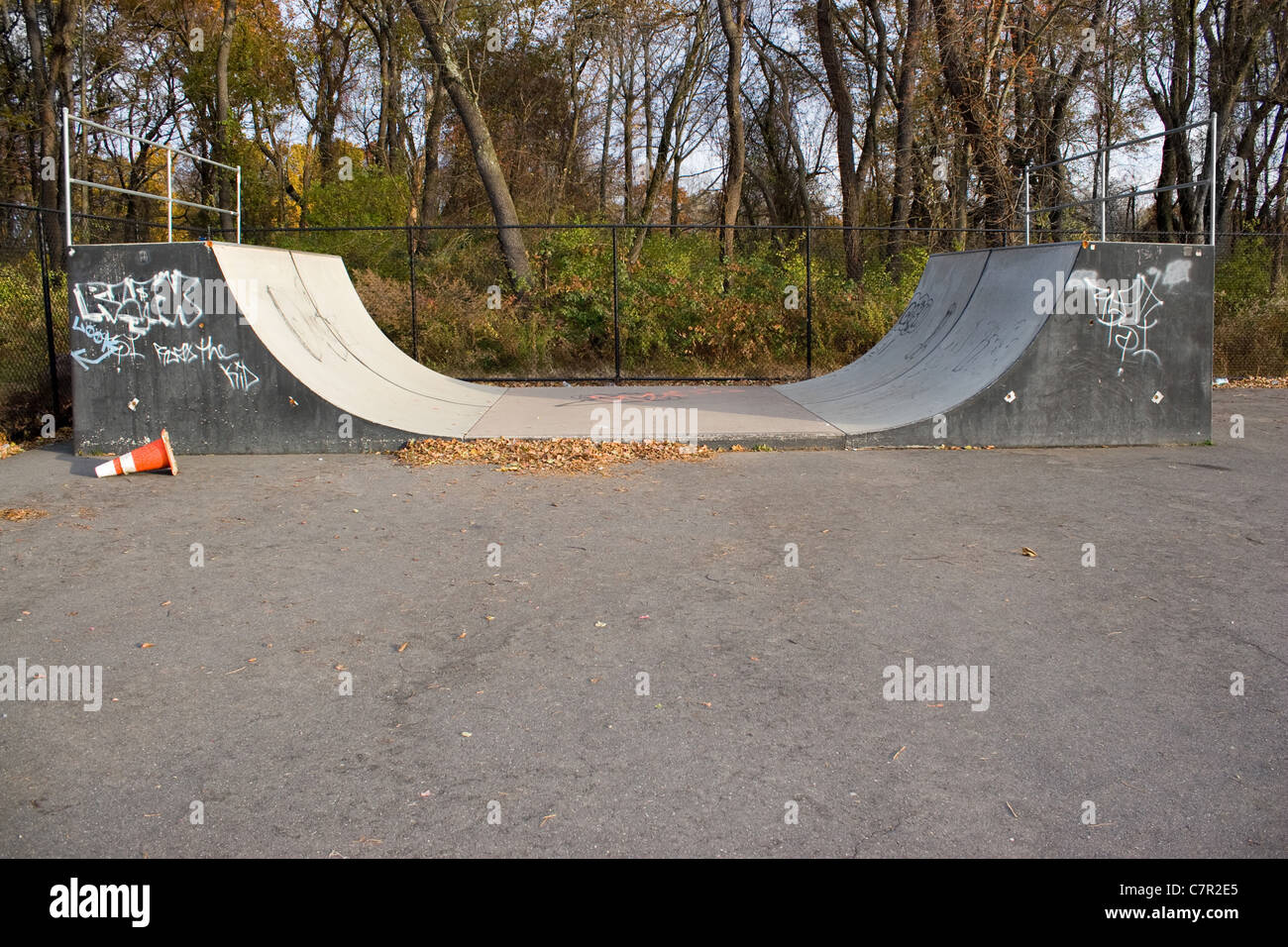 An empty halfpipe at an outdoor skate park. Stock Photo