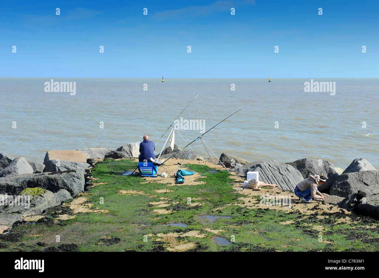 Man fishing off Ness Point Britain's most easterly point Lowestoft