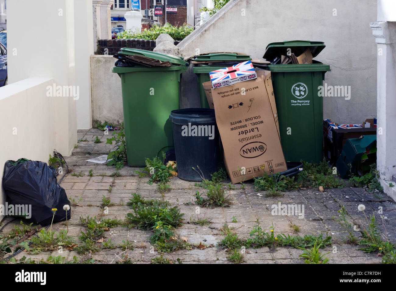 sacks of rubbish and recycling bins in a front garden Stock Photo Alamy